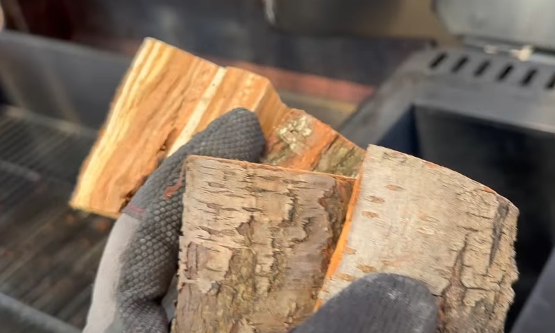 A person holding a piece of wood in their hand