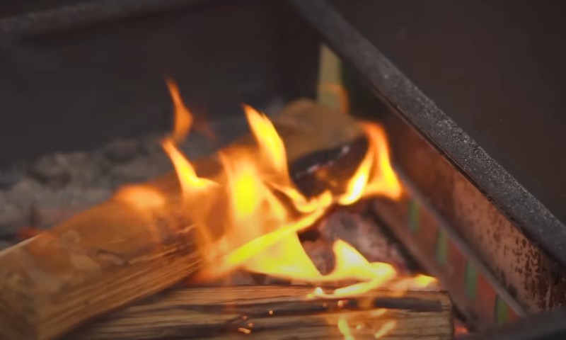 Close-up of vibrant flames dancing in a grill