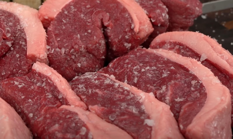 Close-up of raw meat displayed on a butcher's counter